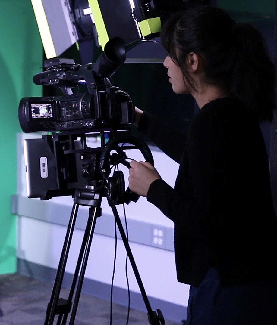 Photo of a technician operating a movie camera