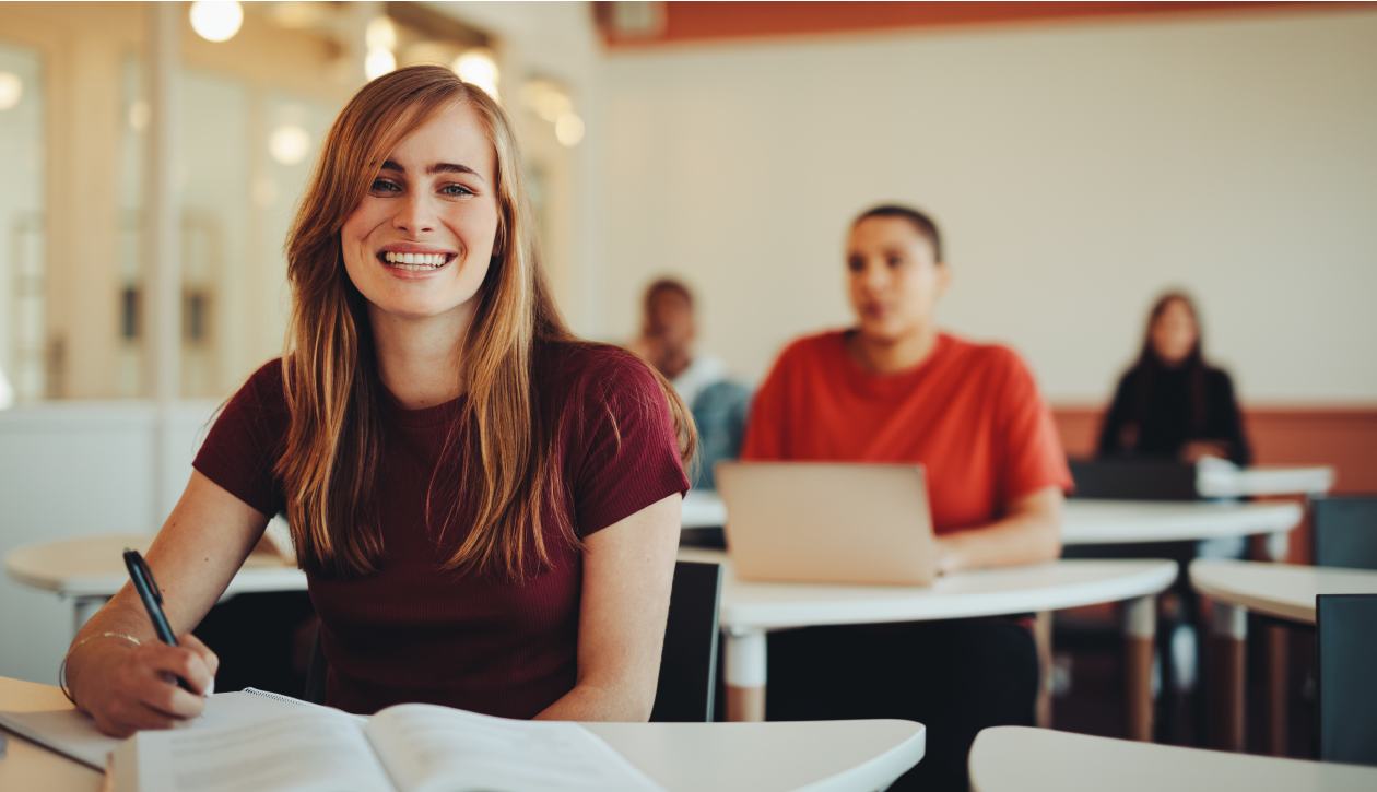 young female white student sitting at desk