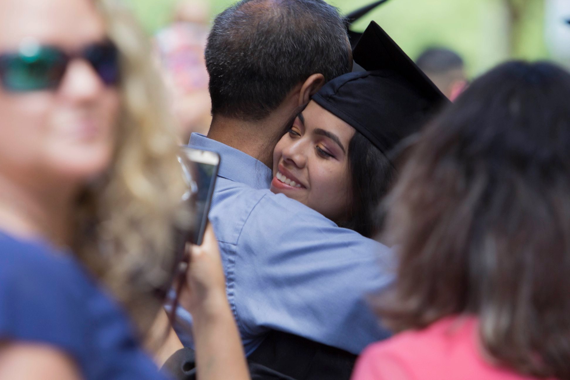 Photo of graduate being hugged