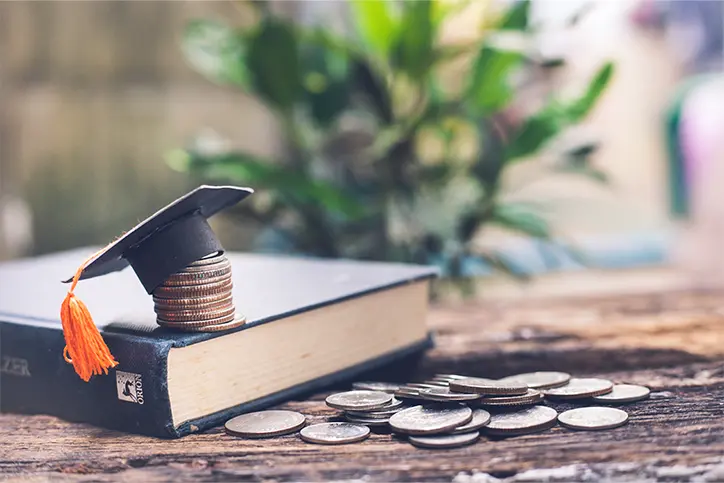 Stack of coins with a grad cap