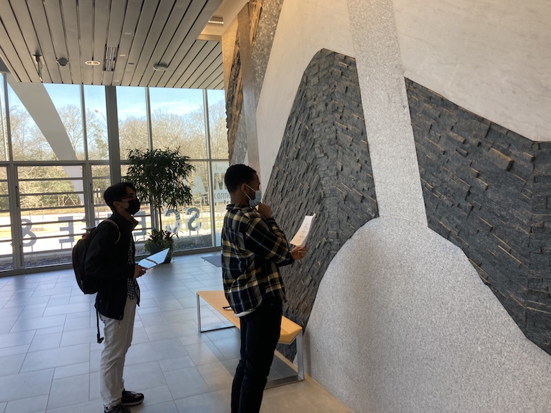 Physical Geology students identifying igneous rocks in the Rock Wall