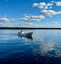 Photo of boat on a lake under a blue sky