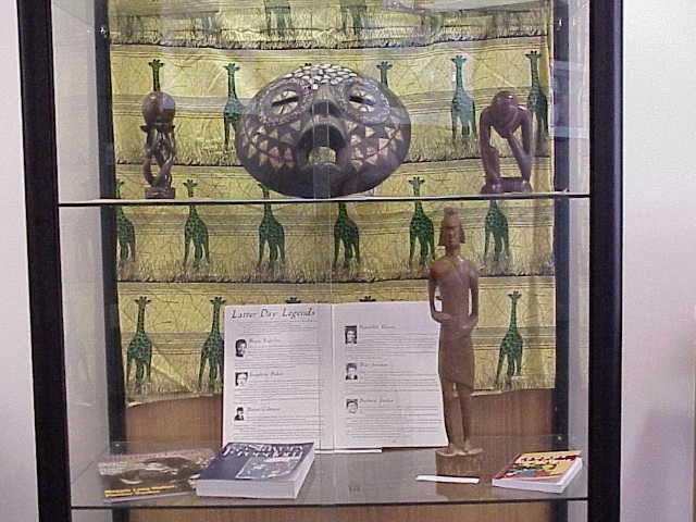 Close up of two shelves (showing a magazine spread on notable Black women of the West)
