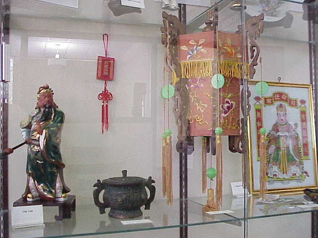 Close up of the City God, a metal pot, the lantern, and the Kitchen God