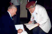 Author Stephen Ambrose at a book signing with veteren Ed Peniche