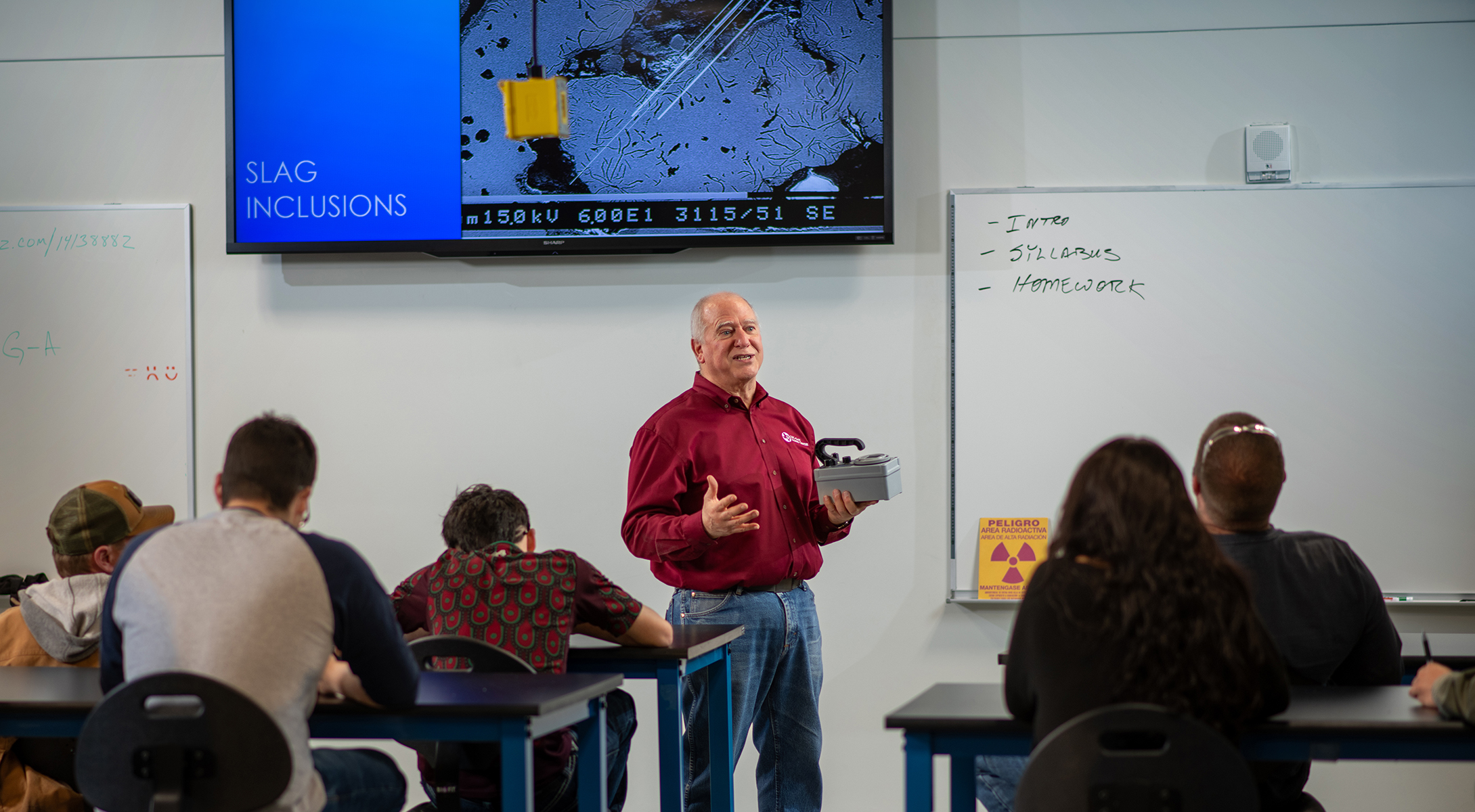 Chris Young, former LSCS inspection technology professor, explains device to students.