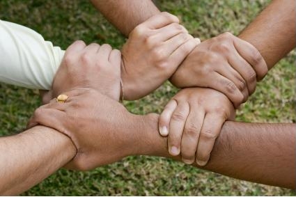 hands interlocking to show teamwork