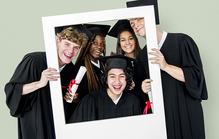 CARE Academy Smiling Students Receiving Diplomas and Posing Behind a Picture Frame