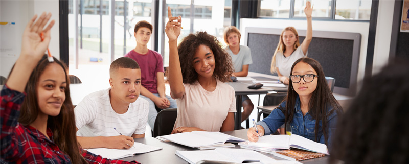 High school students raising hands 