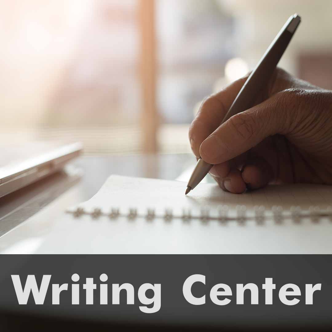The word Writing is written across the bottom of the image as a header. Close up of a hand writing in a notebook.