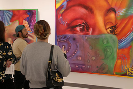 Community members view the large mural artwork by Lone Star College-University Park graduate and professional artist Taylor Barnes at the Taylord: Anemoia exhibit in the Visual & Performing Arts building on campus.