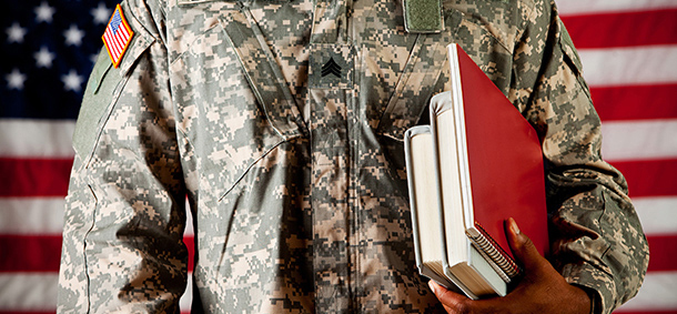 person in military uniform in front of United states flag