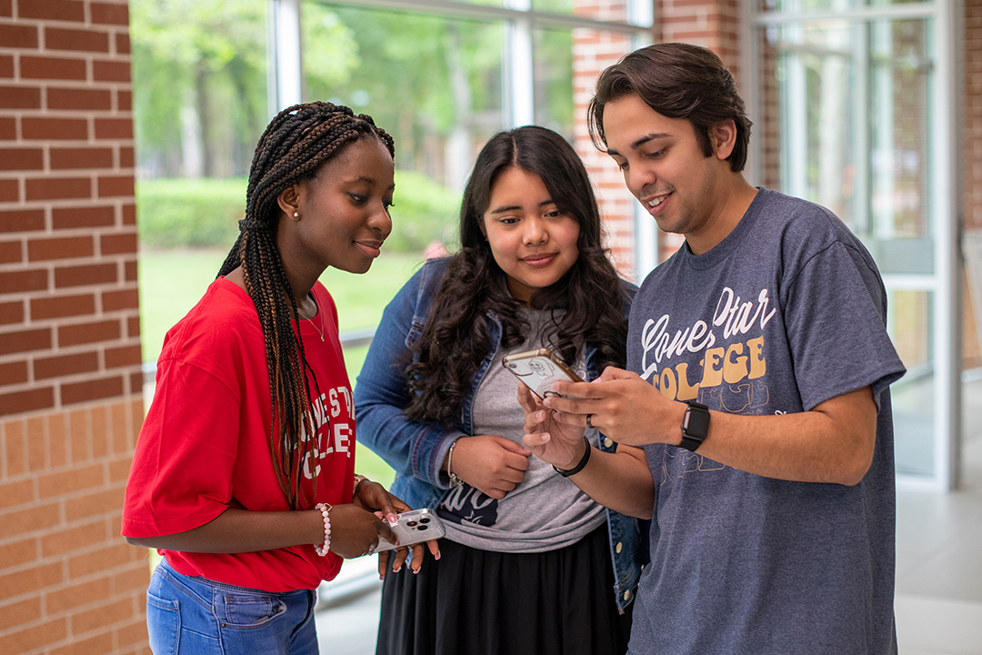 Students looking at a phone, Nelnet