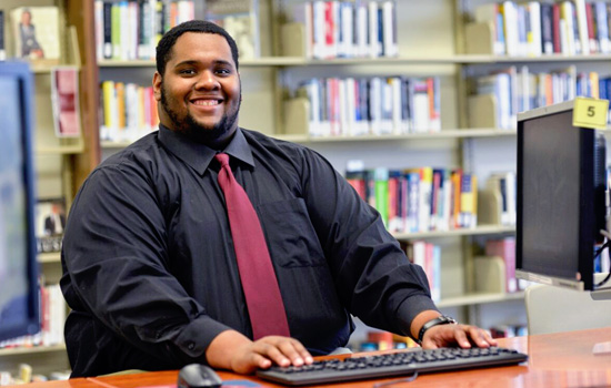 Staff member sitting in front of laptop