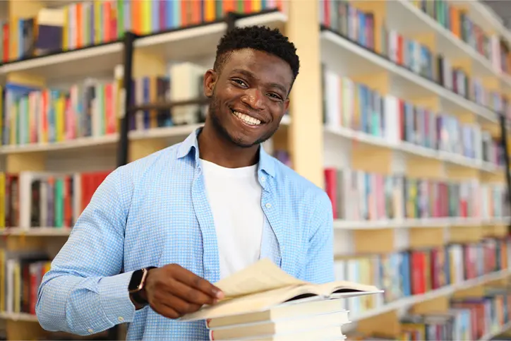 Smiling student holding a book
