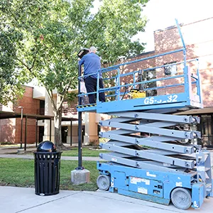 Groundskeeper on a lift