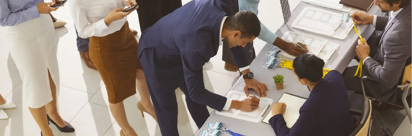 A group of people signing a clipboard