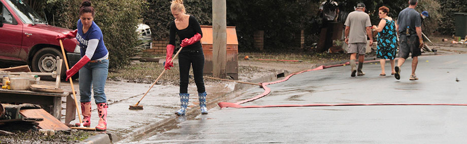 photo of flood aftermath and people cleaning up