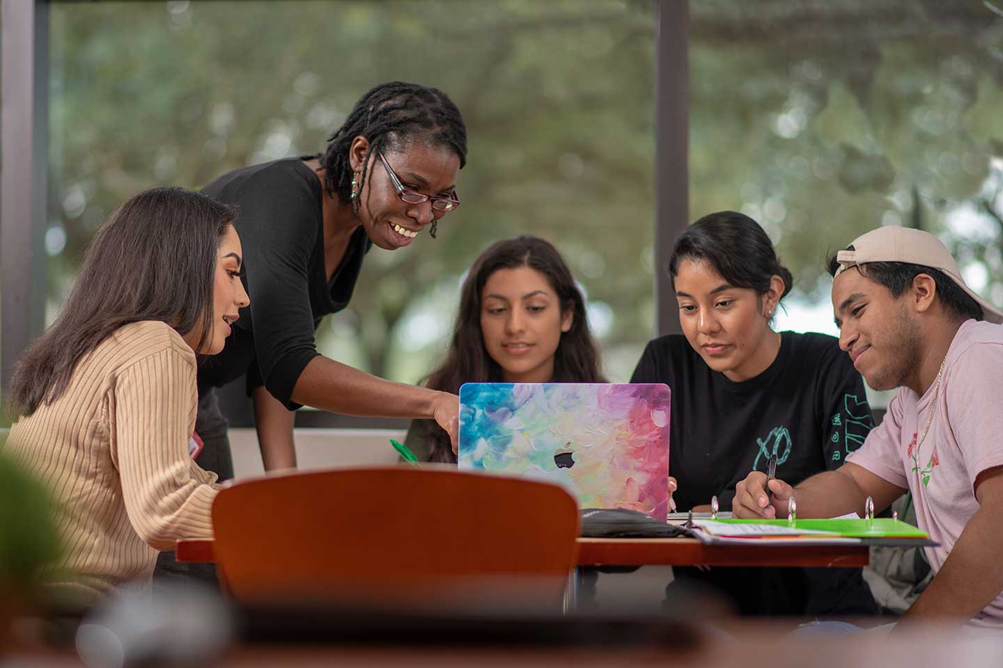 Students at table, led by instructor