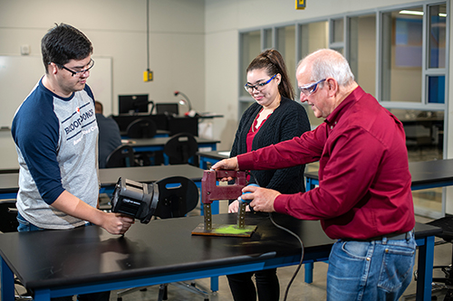 Lone Star College Foundation established the Chris Young Memorial Scholarship in honor of Chris Young, right, former LSCS inspection technology professor.