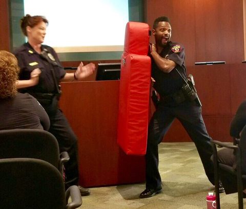 Officer Marshall (right) assists in a personal defense class for employees with Deputy Chief Sandra Joachim.