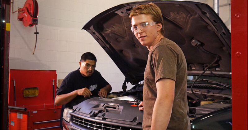 Automotive Technician students working on a car