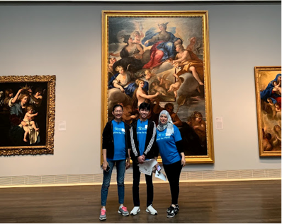 Photo of students in front of artwork