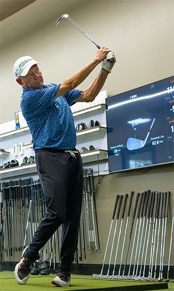 Golf pro swinging a club