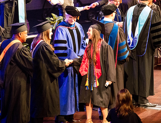 photo of lone star college university park graduates receiving degrees