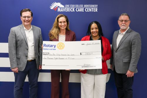 Dr. De' Reese Reid-Hart, president of Lone Star College-Montgomery, and Matthew Samford, dean of Student Success and Retention, accept a $2,800 donation from Cindy Heiser, president of The Rotary Club of The Woodlands, and Matt Bottorff, president-elect o