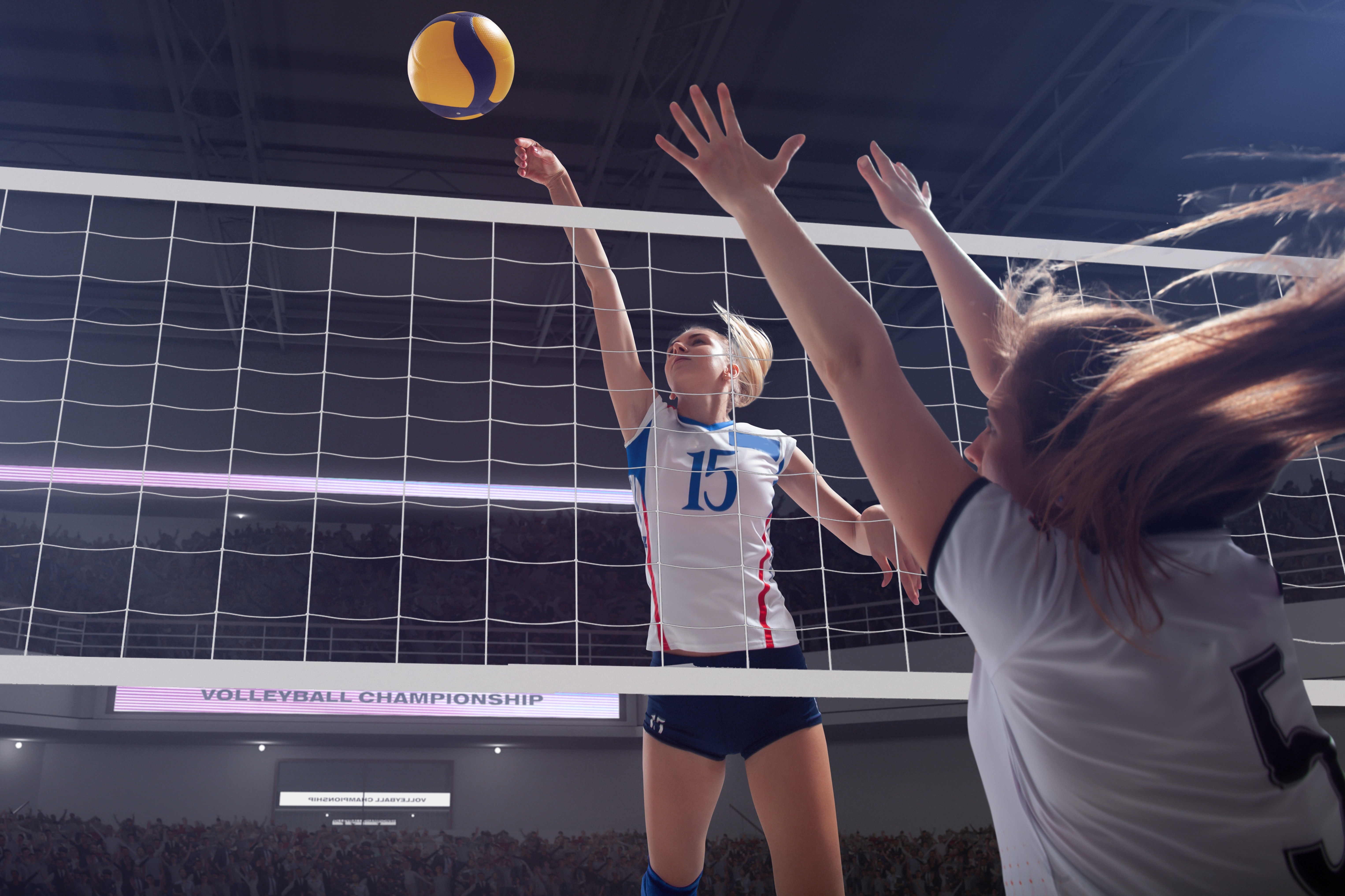 volleyball player attacking the net