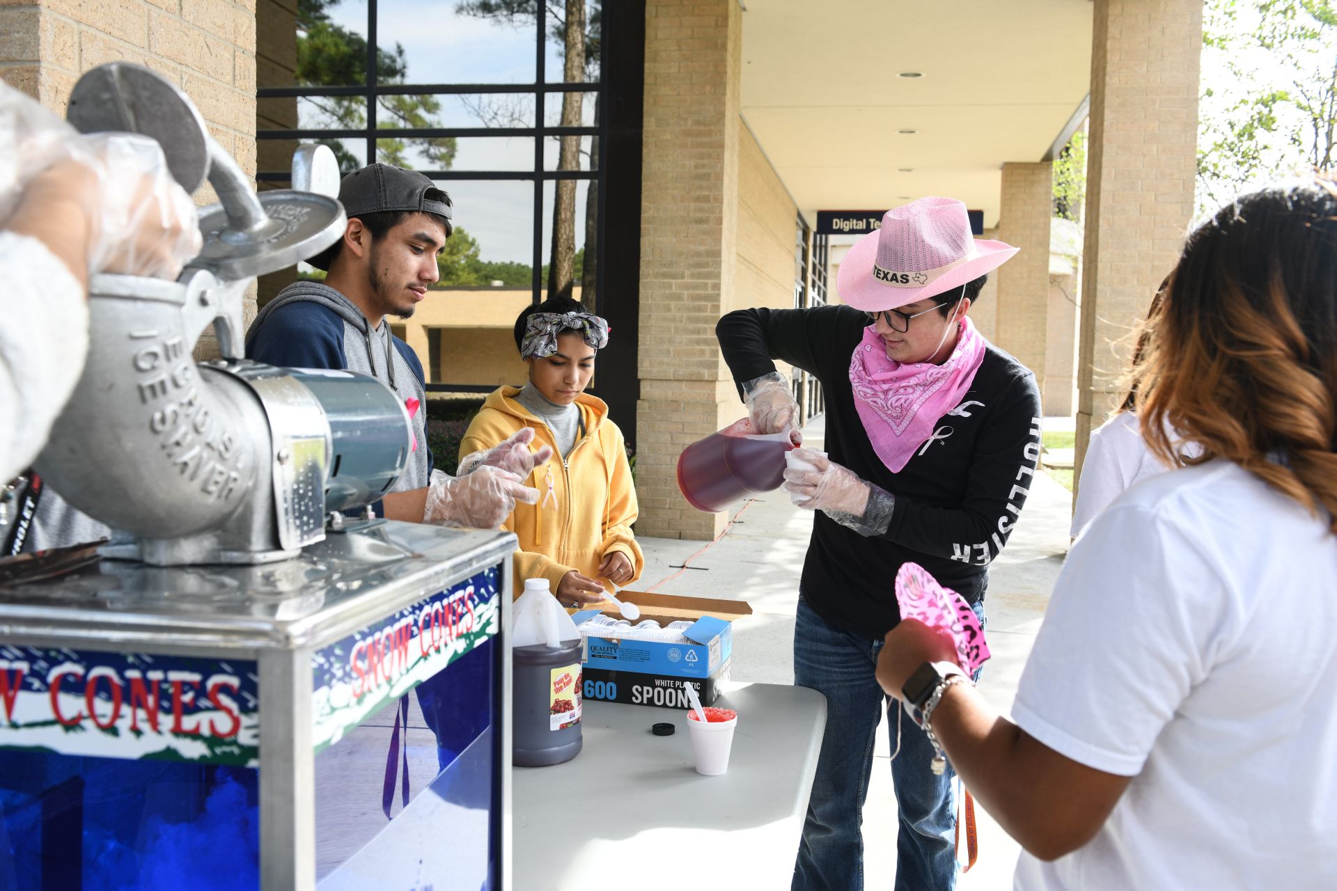 Photo of students giving away snow cones at event