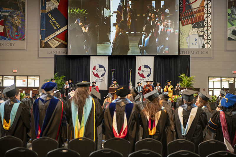 group of happy Hispanic students graduating 