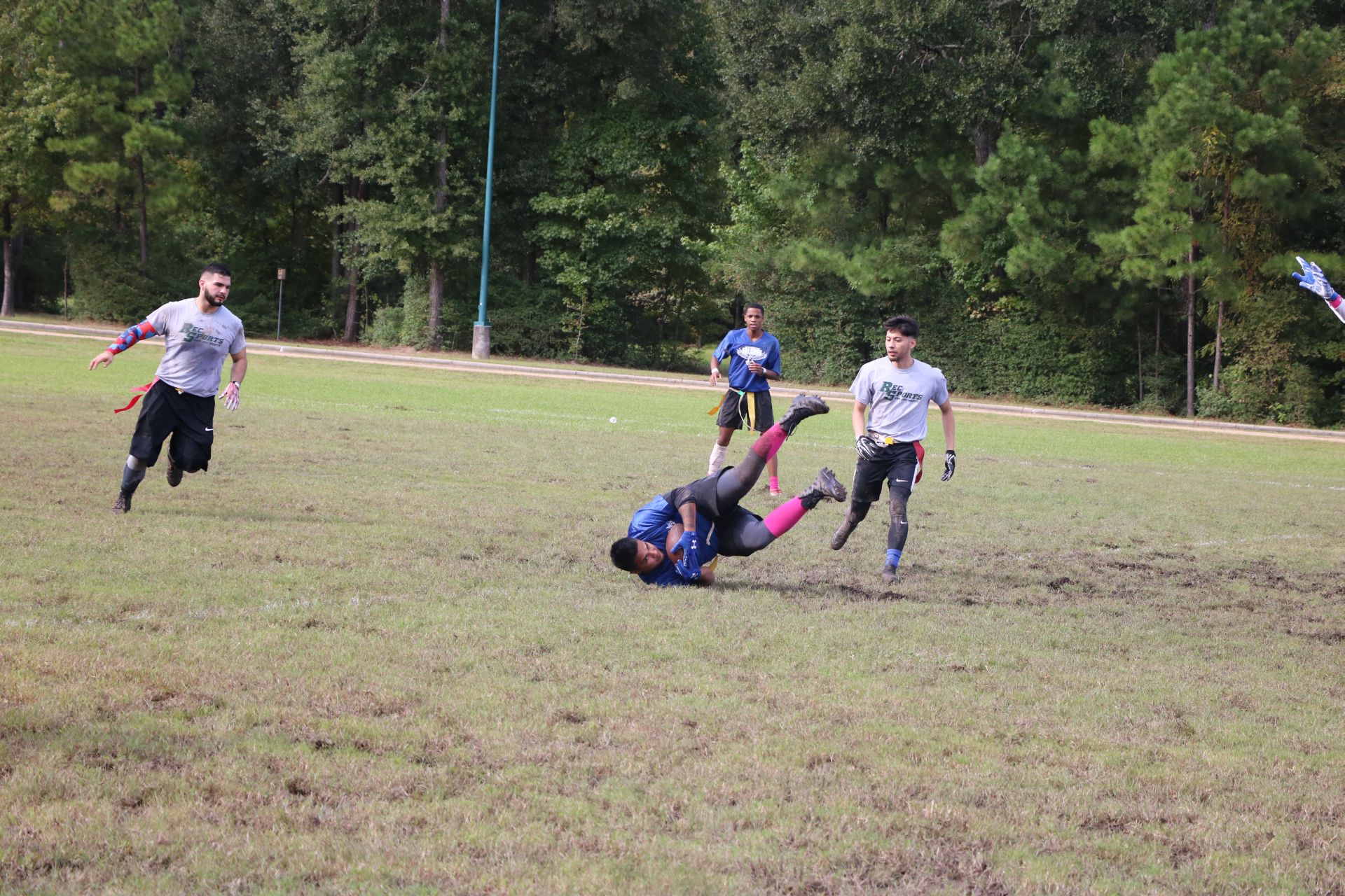 Photo of students from two different teams playing flag football