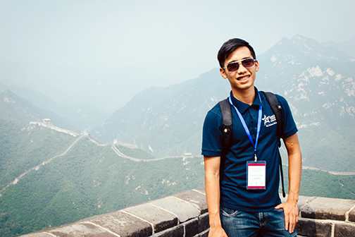 Lone Star College Study Abroad Program student posing in front of the Great Wall of China landscape.