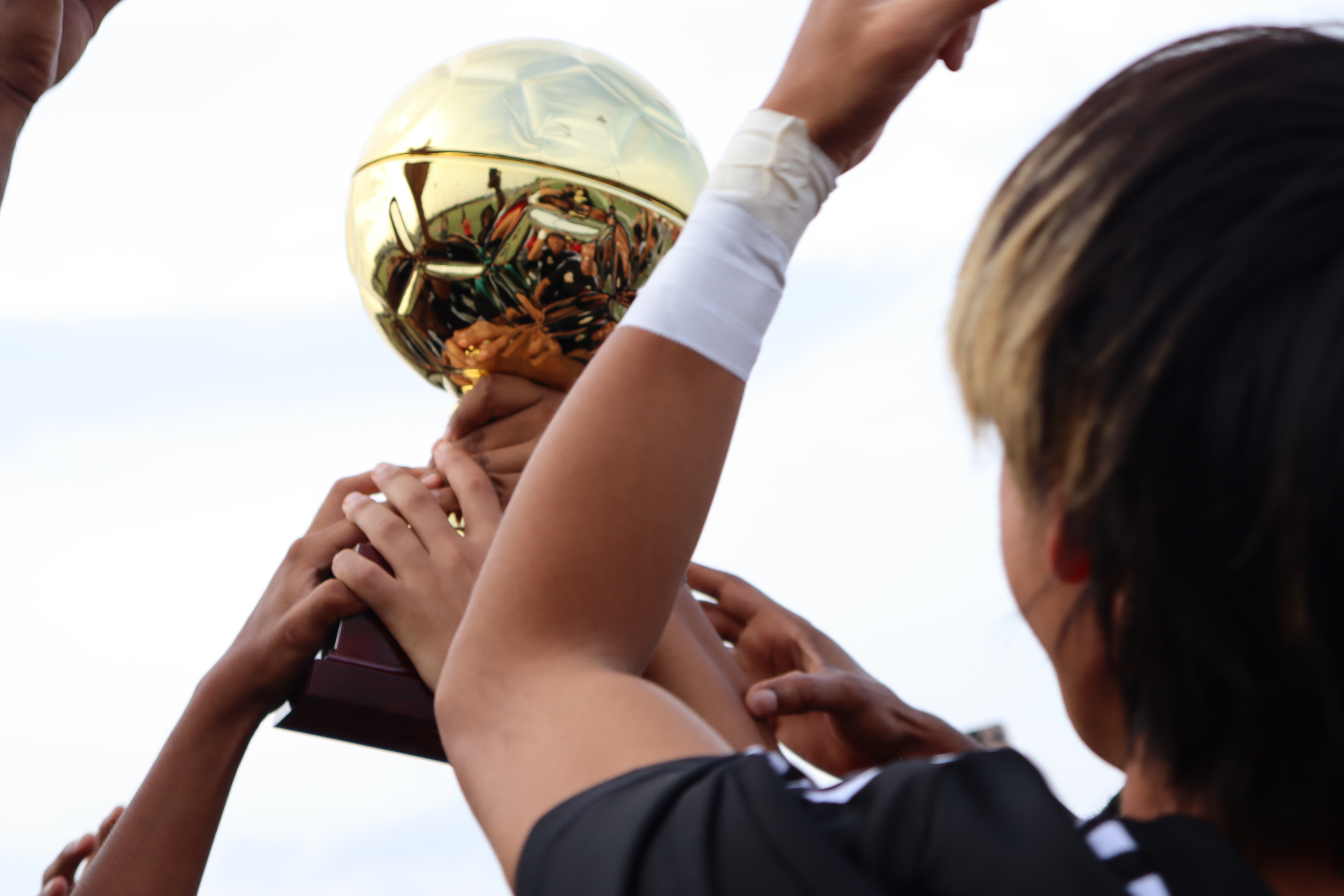 participate holding a trophy