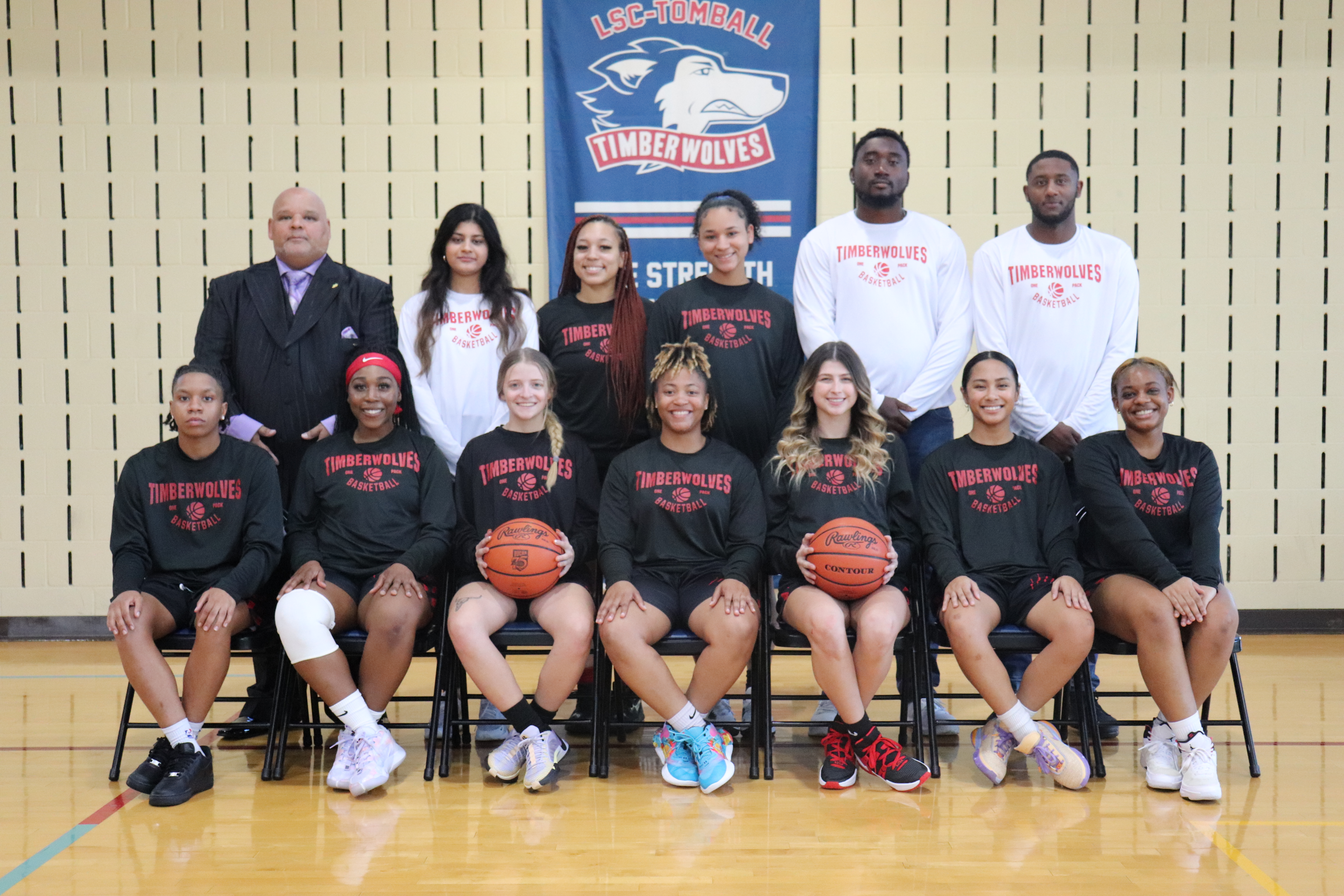 This is a photo of the Fall 2023 Women's Basketball team with the head coach and assistant coaches.