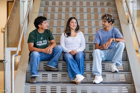 Lone Star College students sitting on stairs.