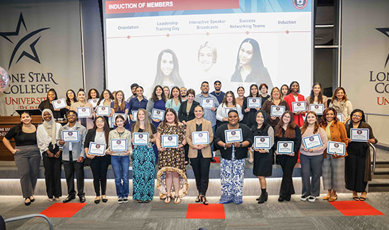 Beaming with pride, NSLS inductees stand alongside LSC-University Park President Virginia M. Fraire, Ph.D. (middle, center) during the induction ceremony. They celebrate their commitment to leadership and personal development.