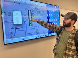 Photo of student troubleshooting process tech system