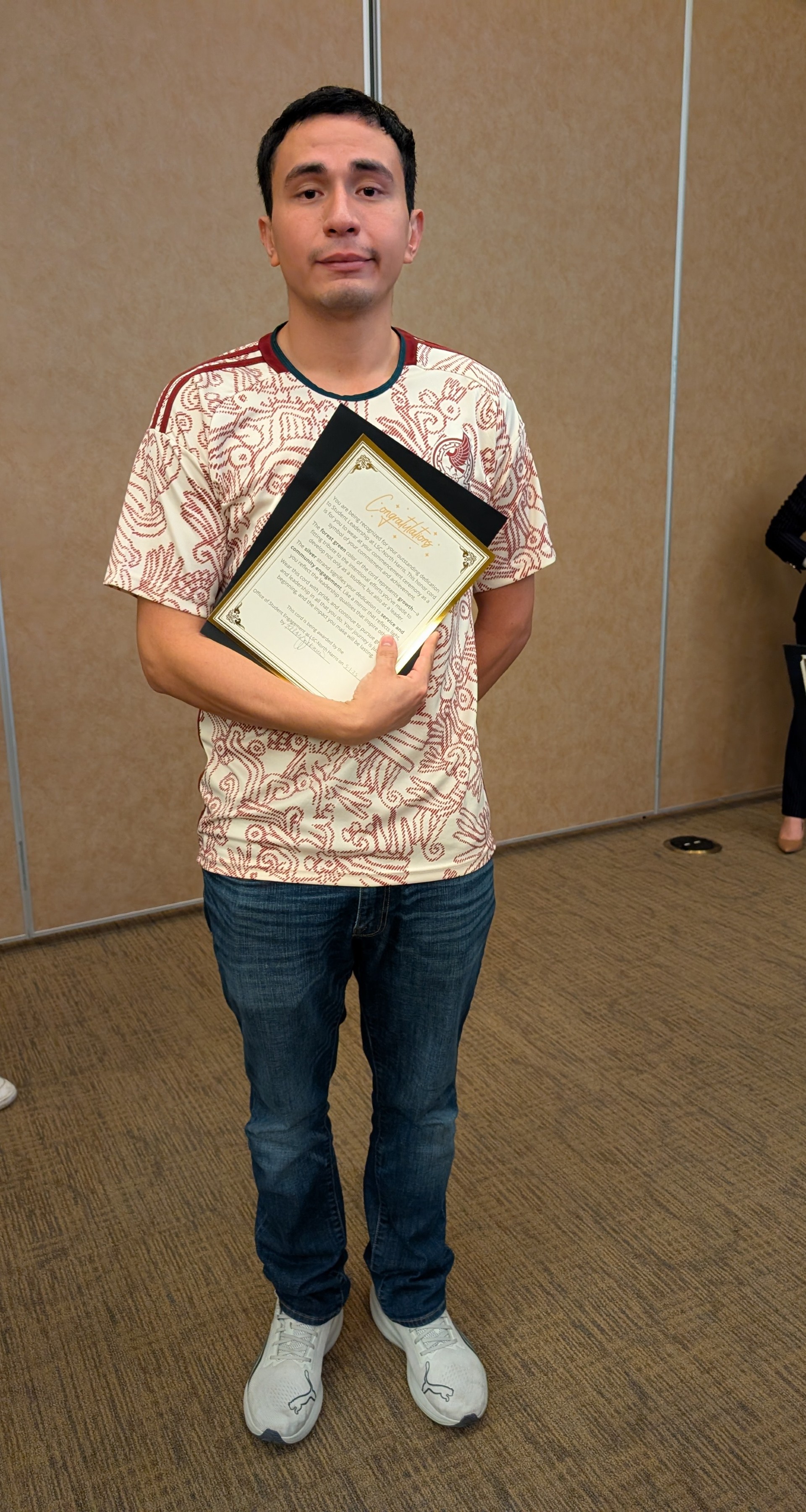 Student holding award