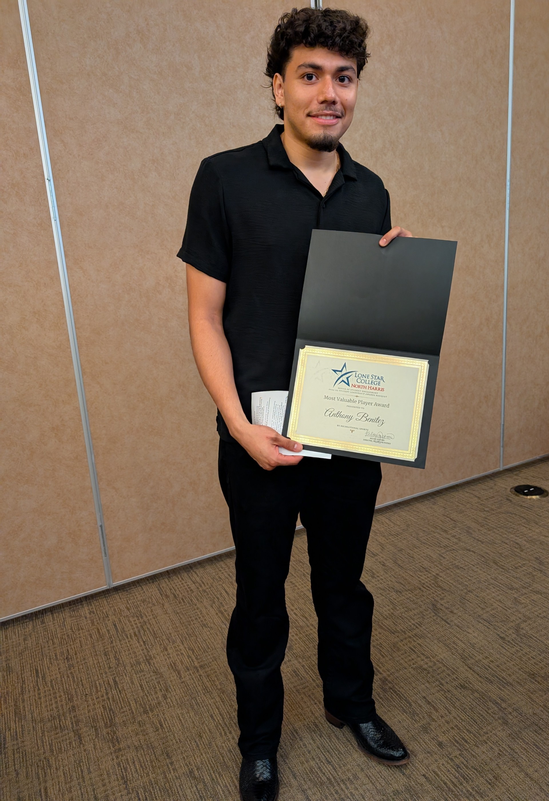 Student holding award