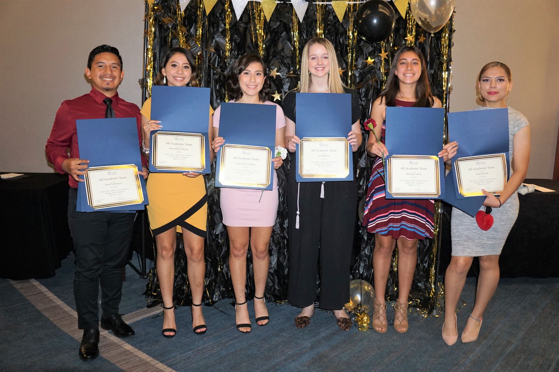 Photo of students posing for photo holding their awards