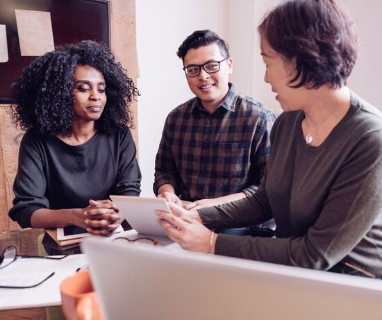 Photo of woman helping couple with taxes