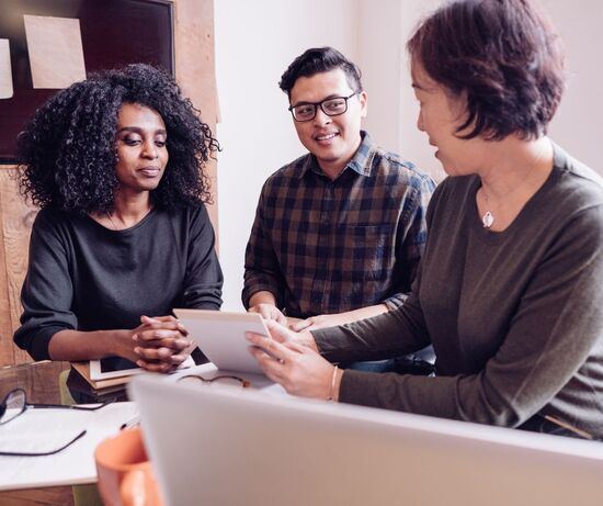 Photo of woman helping couple with taxes