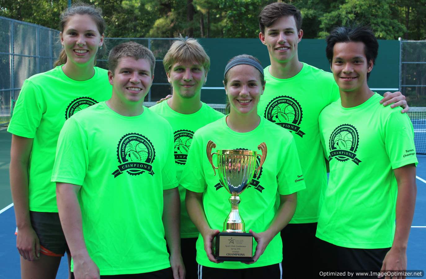 Photo of students from UofH posing for a photo with a trophy