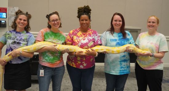 librarians holding a large snake