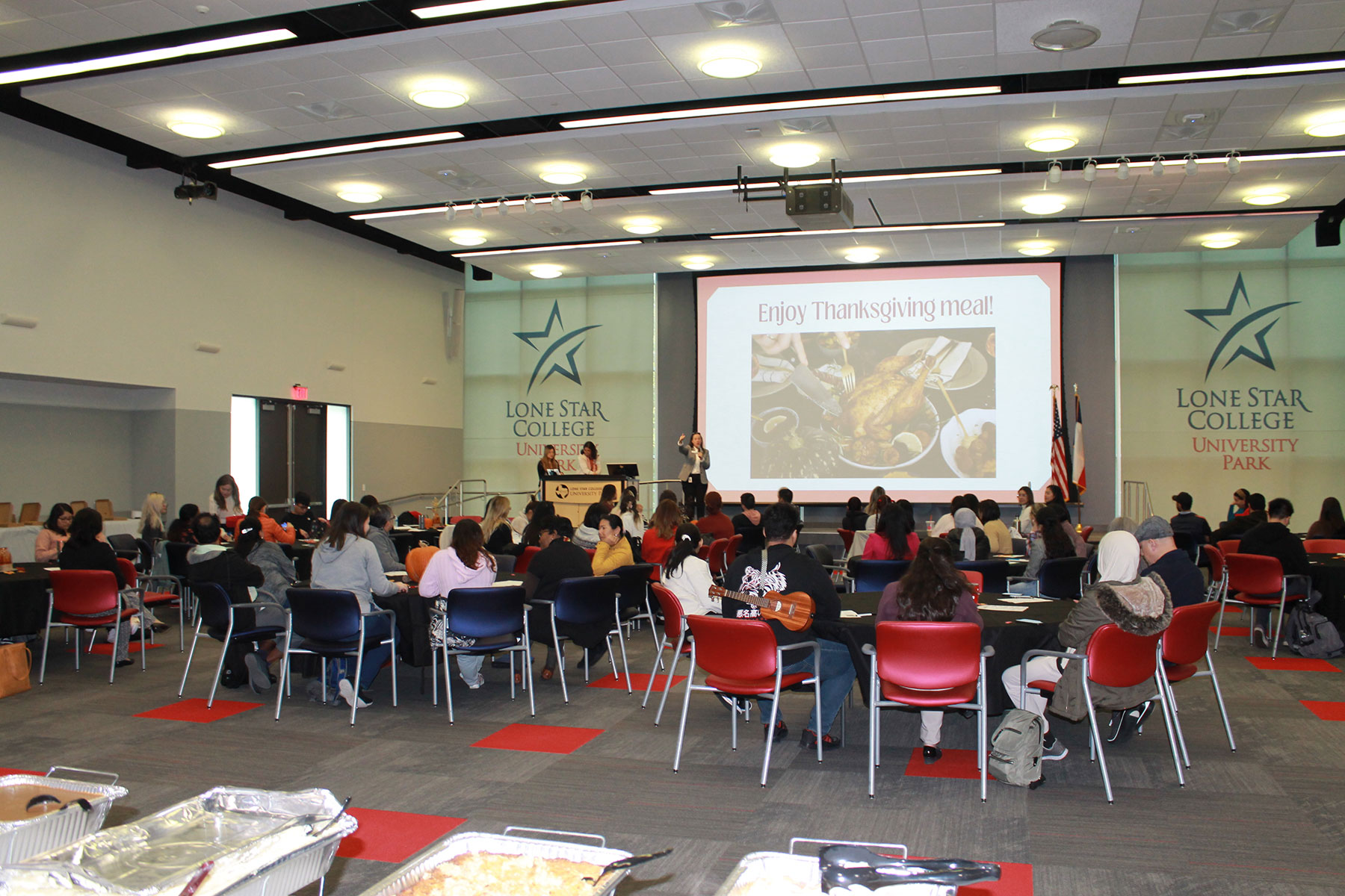 ESOL Students Sitting at Tables Enjoying their Thanksgiving Meal