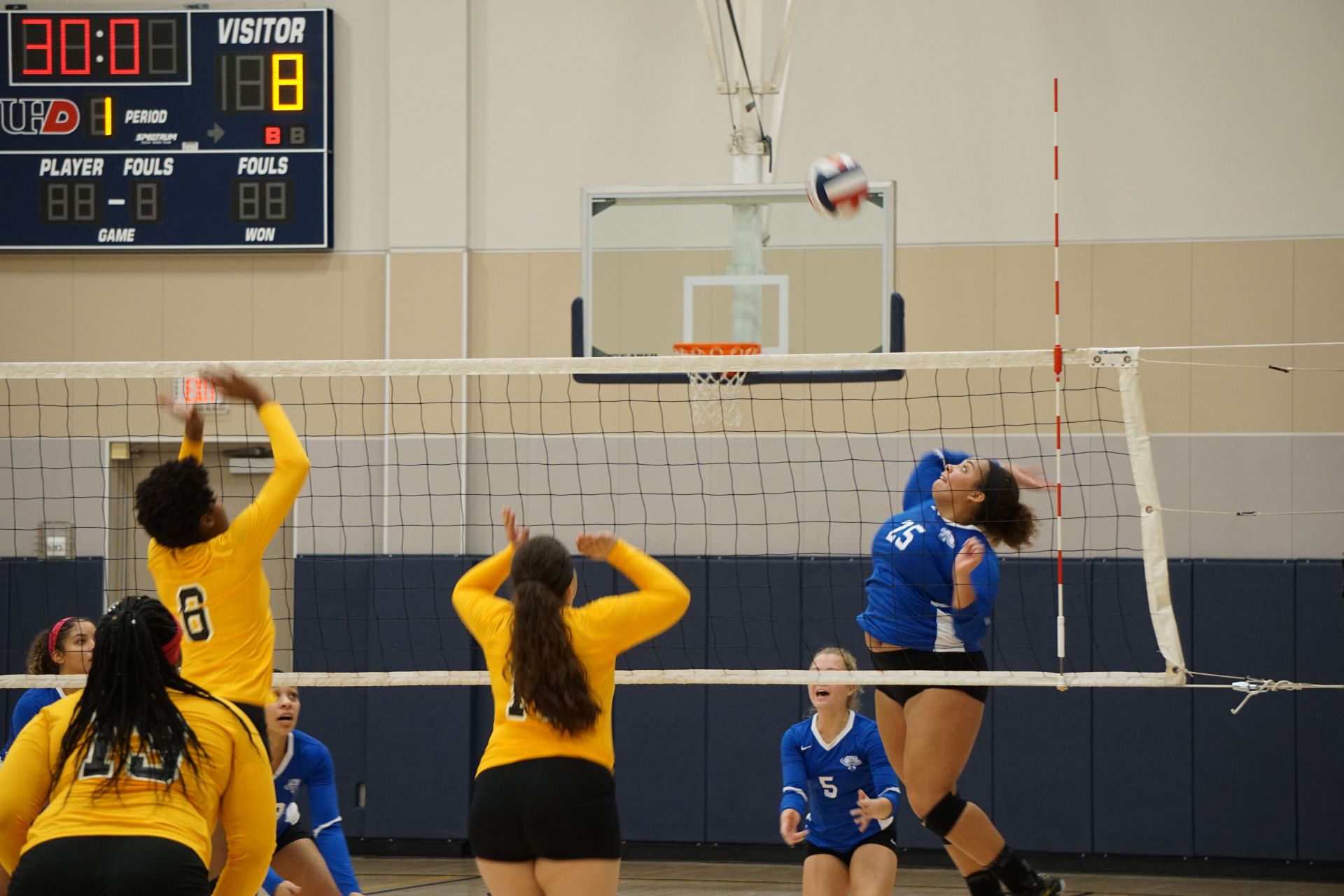 Photo of students from two different teams playing volleyball