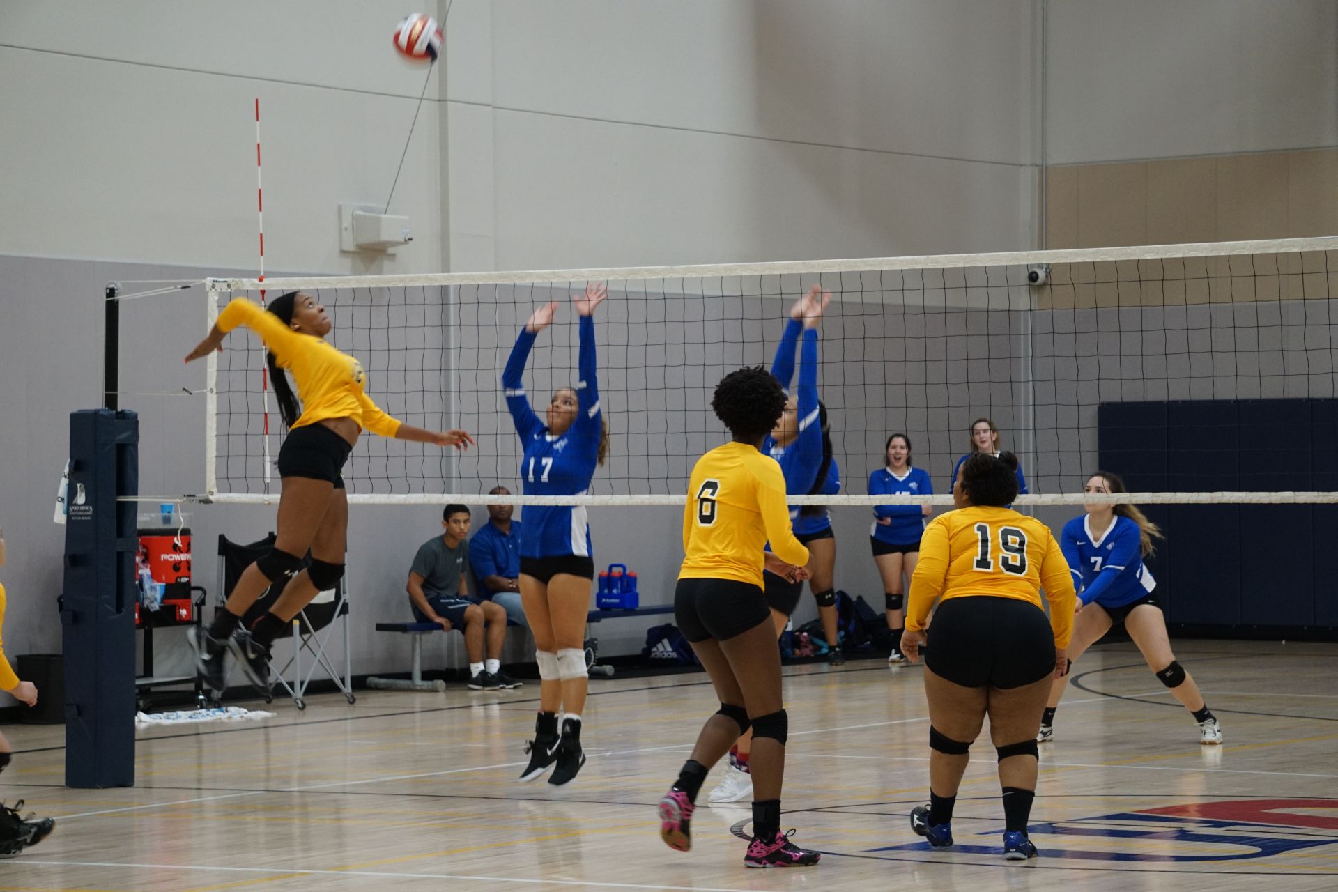 Photo of students from two different teams playing volleyball